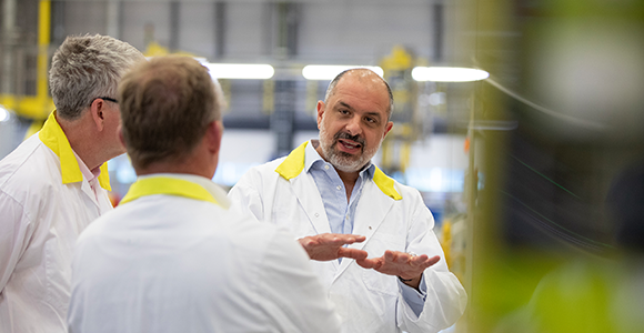 3 people in lab coats talking