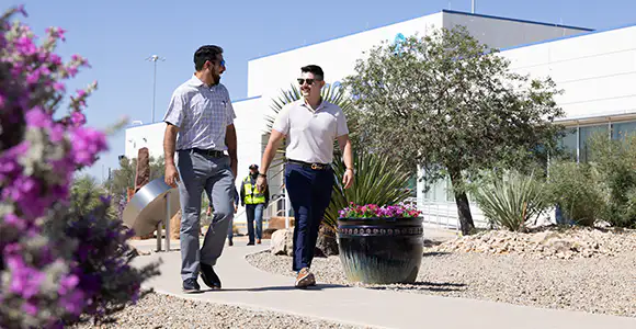 two staff members walking on site